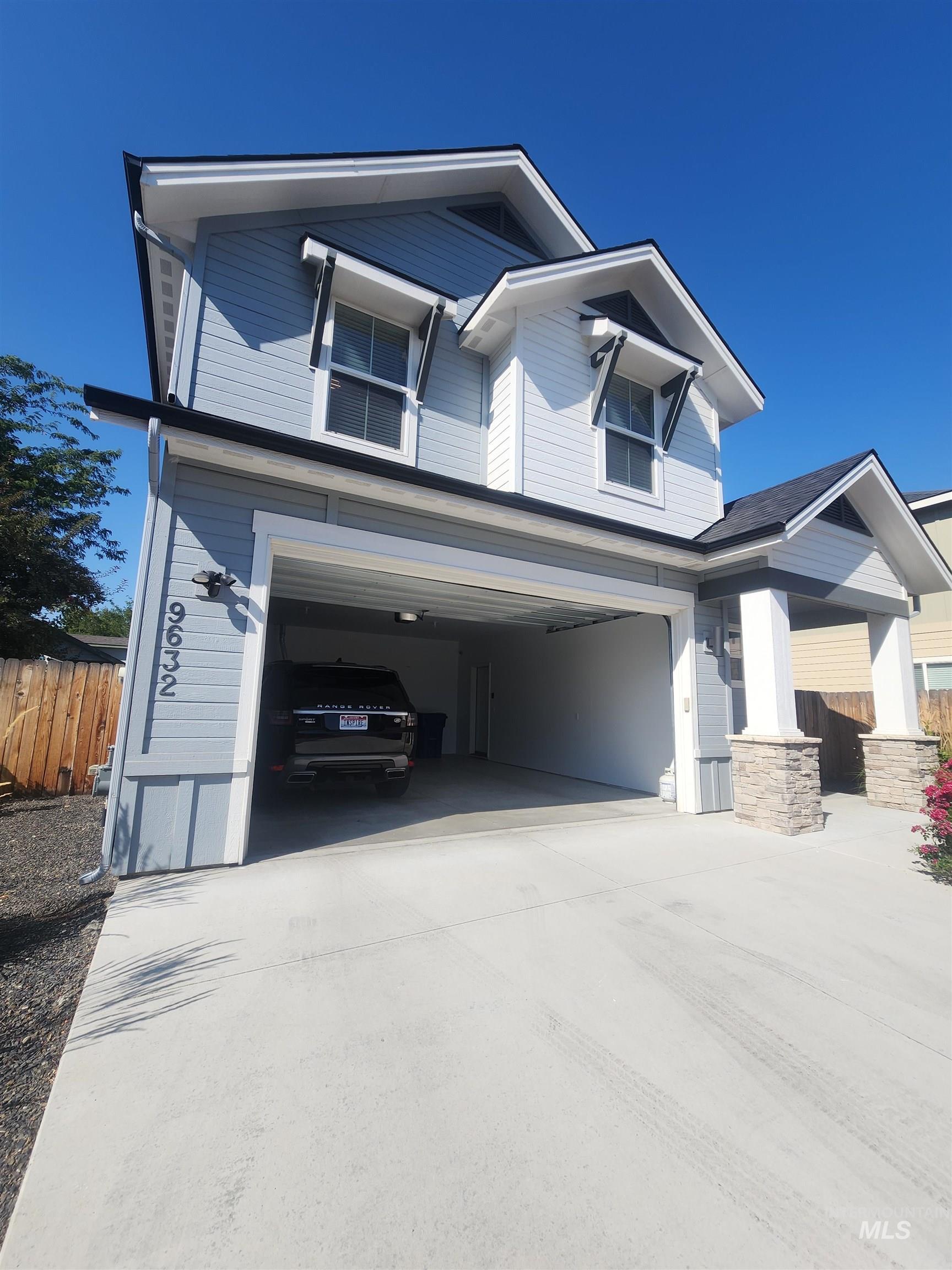 View of front of home featuring a garage and driveway