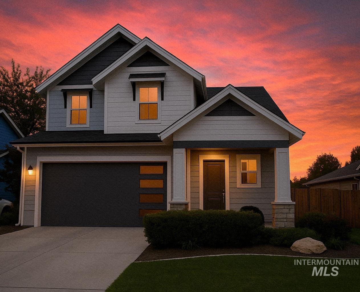 View of front of home featuring a garage, driveway, and a porch