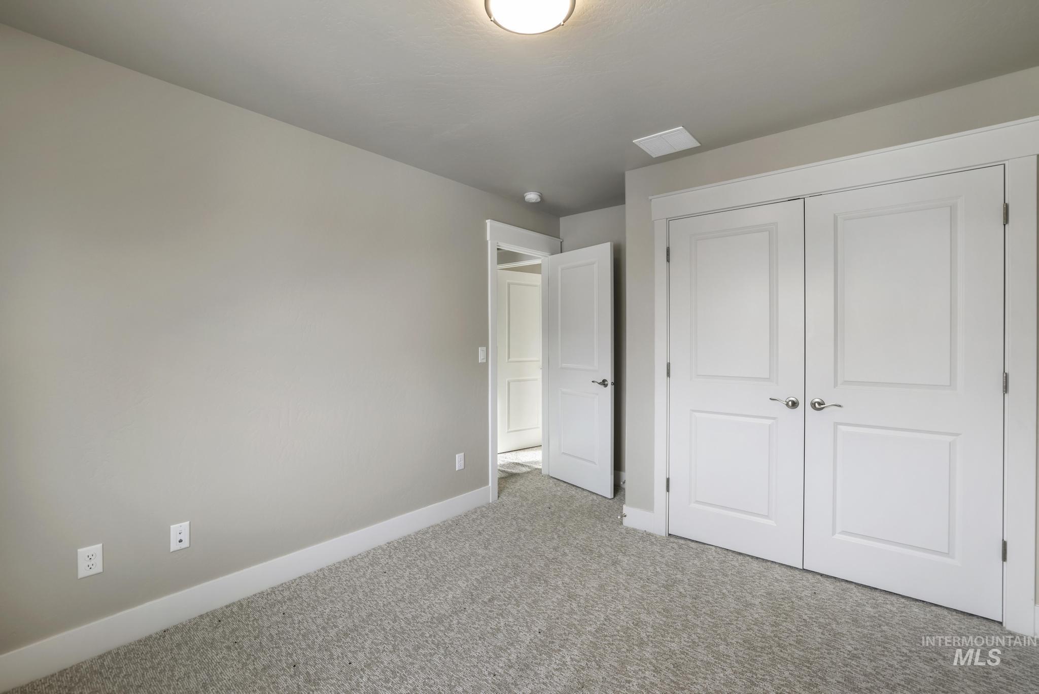 Unfurnished bedroom with carpet floors and a closet