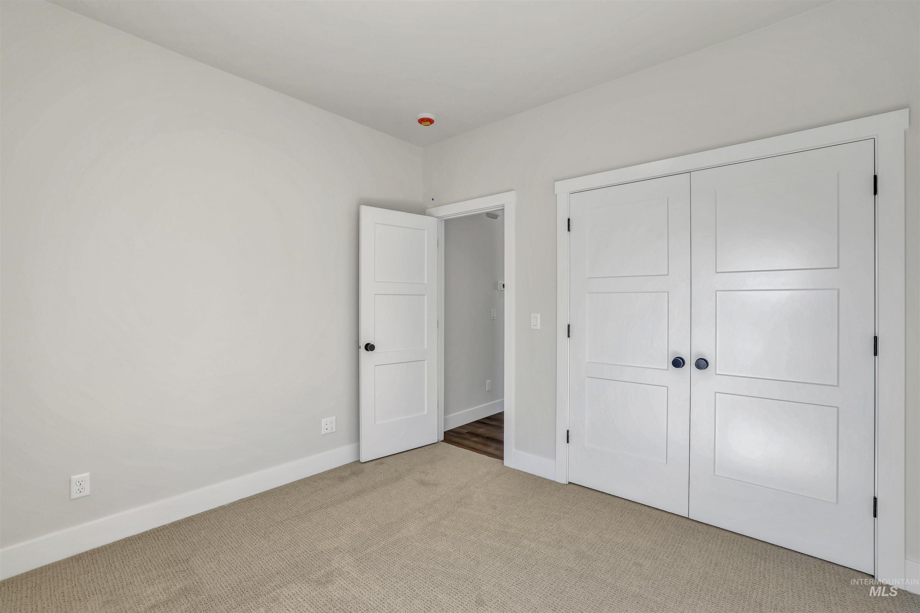 Unfurnished bedroom with carpet floors and a closet