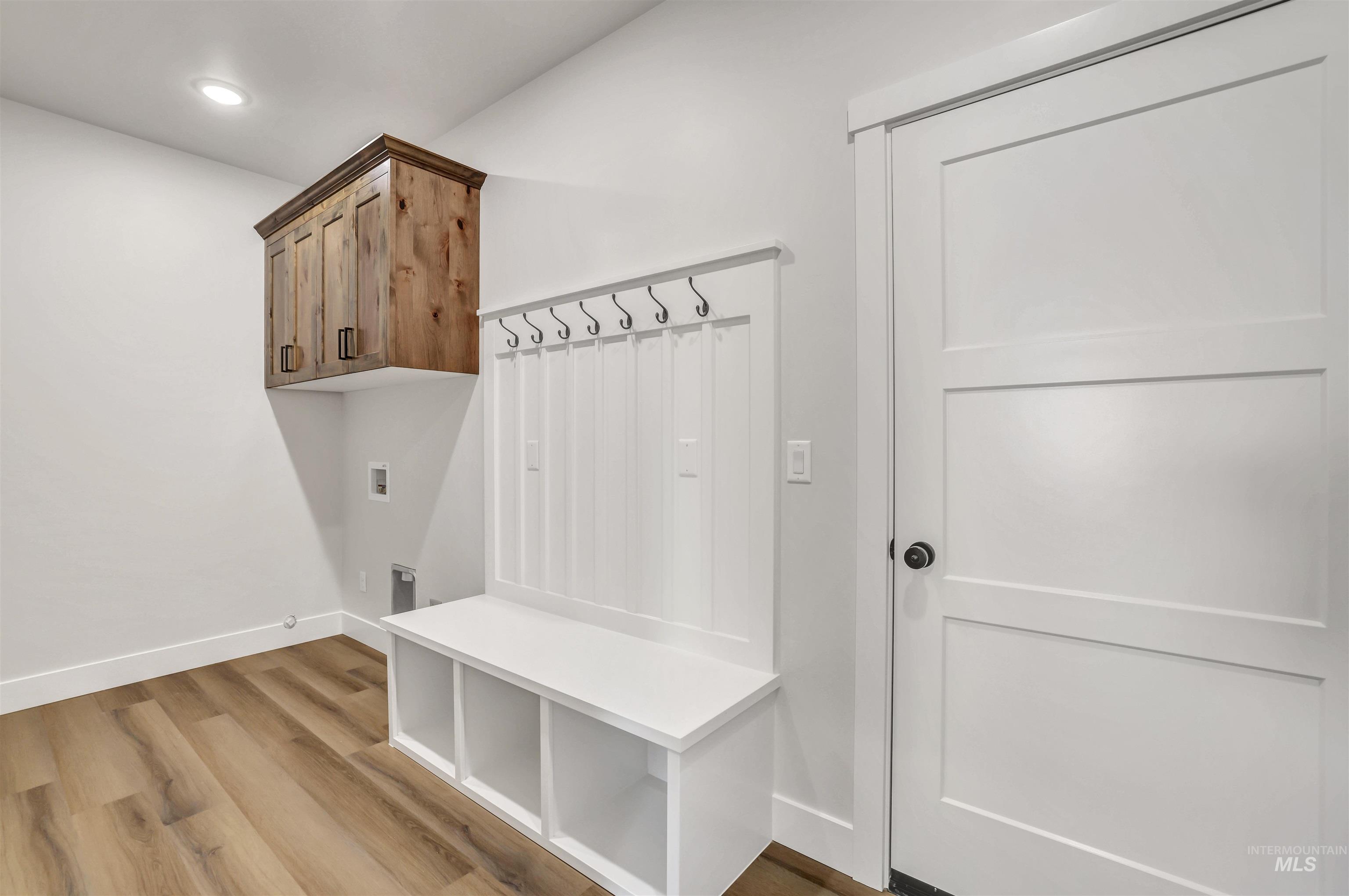 Mudroom featuring light wood finished floors and recessed lighting