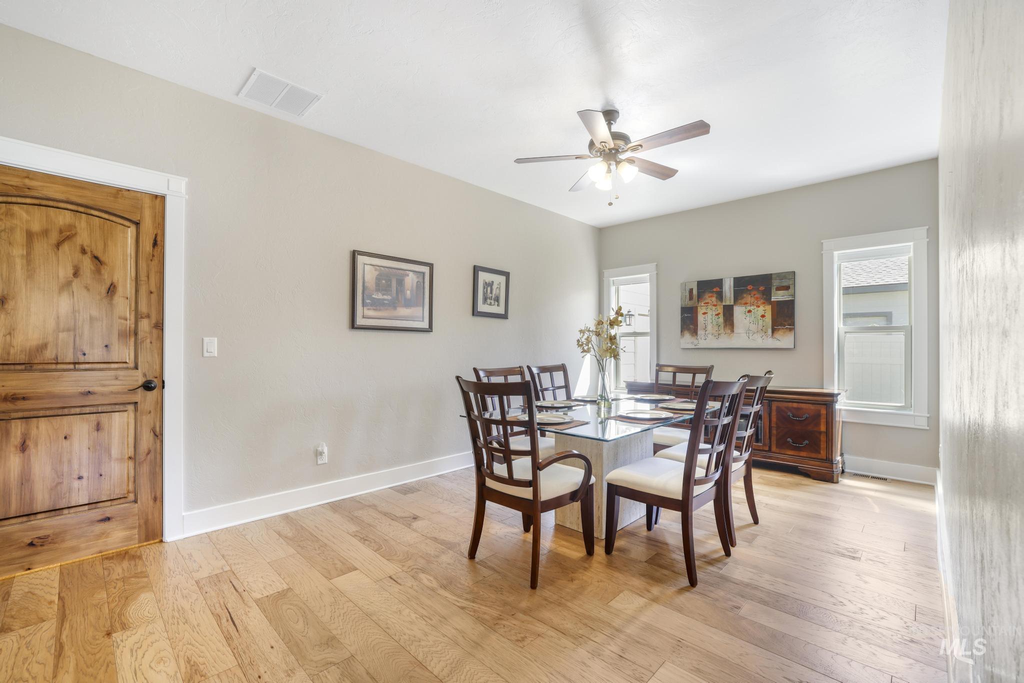 Dining room featuring light wood finished floors and a ceiling fan