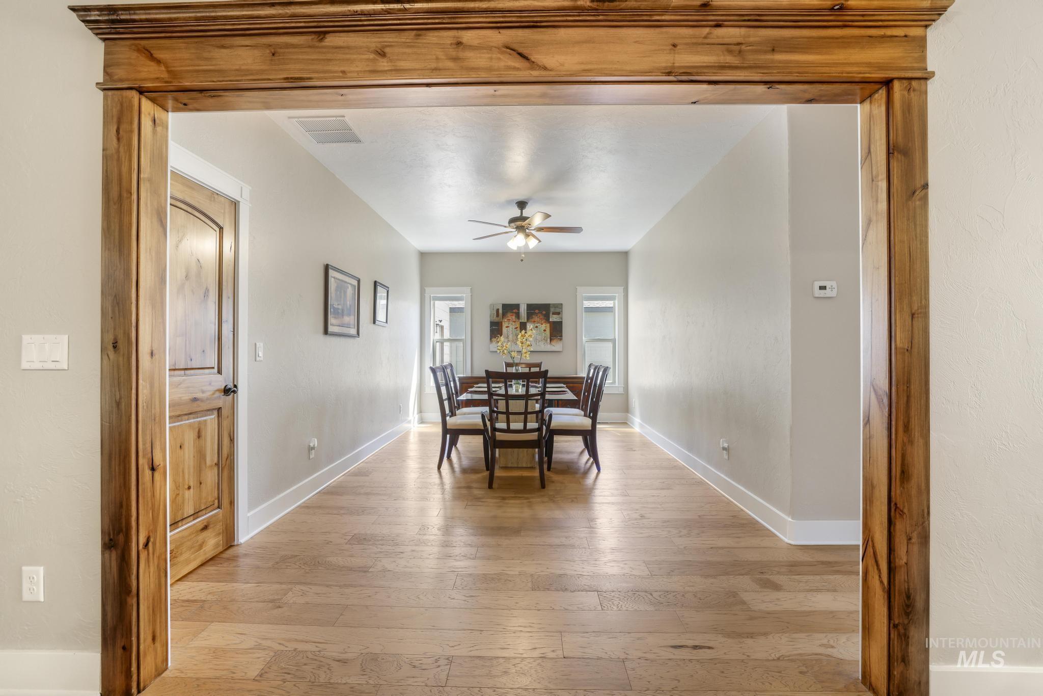 Dining area featuring light wood-type flooring and a ceiling fan