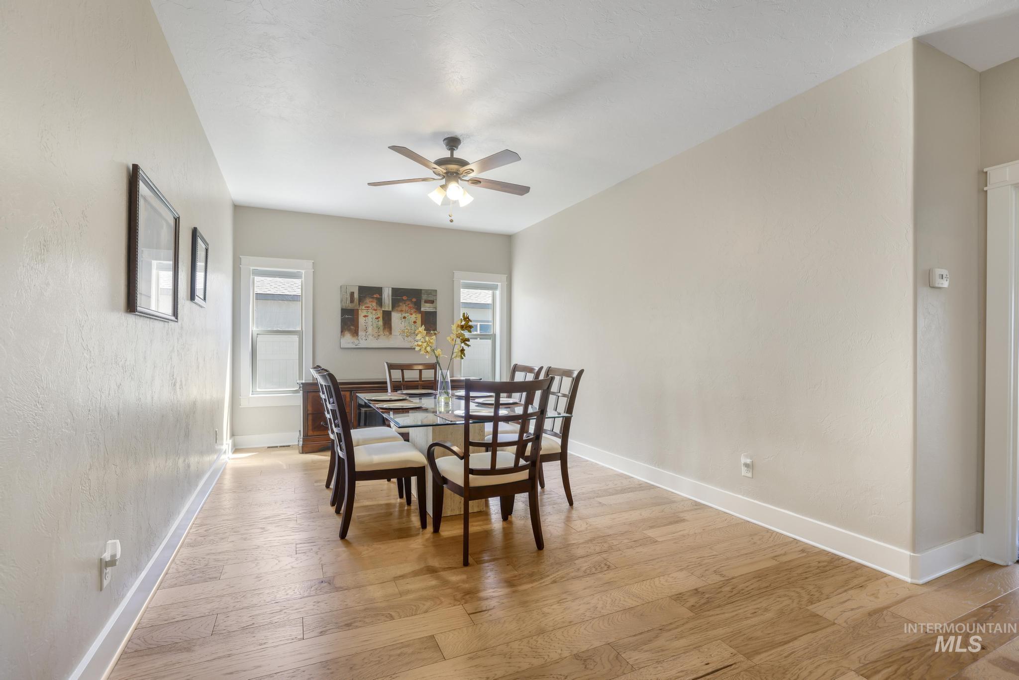 Dining space featuring light wood finished floors and a ceiling fan