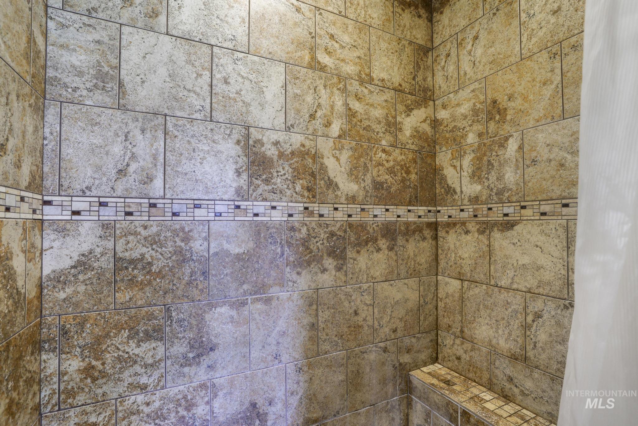 Bathroom view of a tile shower