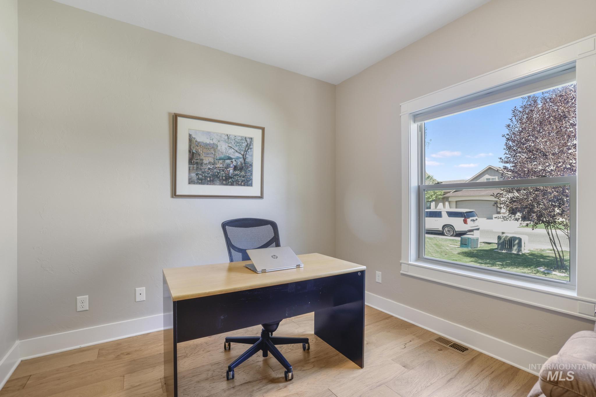 Office space with baseboards and light wood finished floors