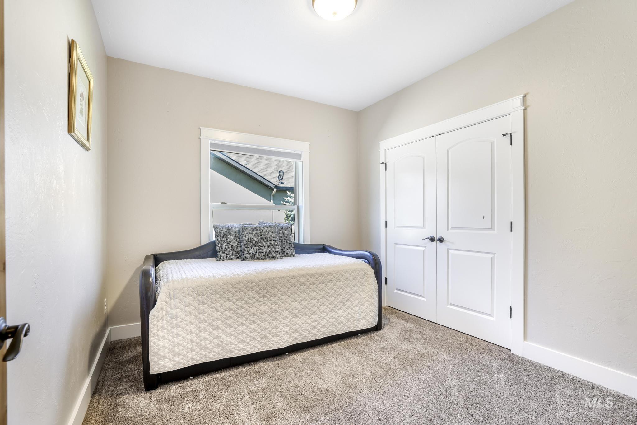 Bedroom with carpet flooring and a closet