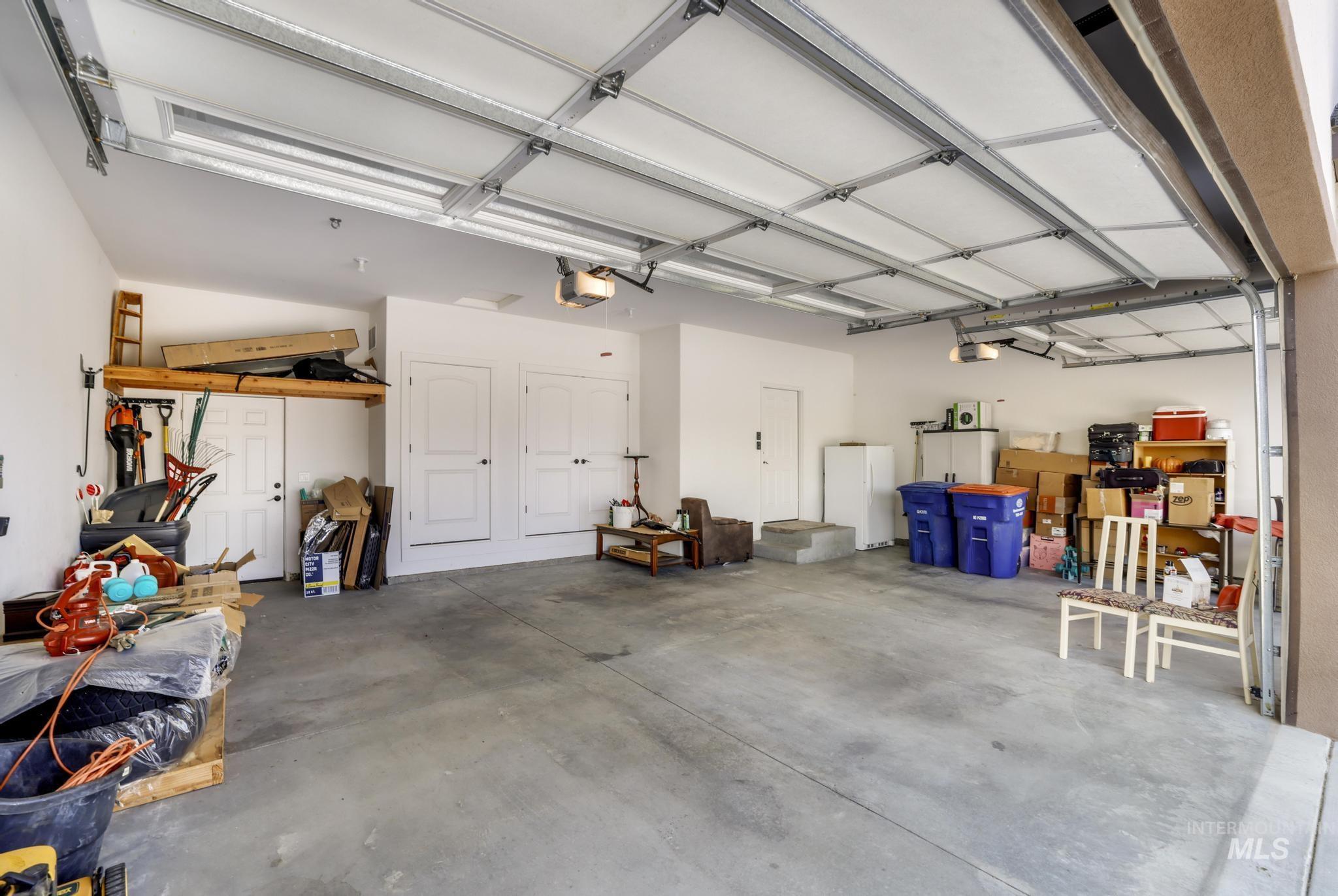 Garage featuring freestanding refrigerator