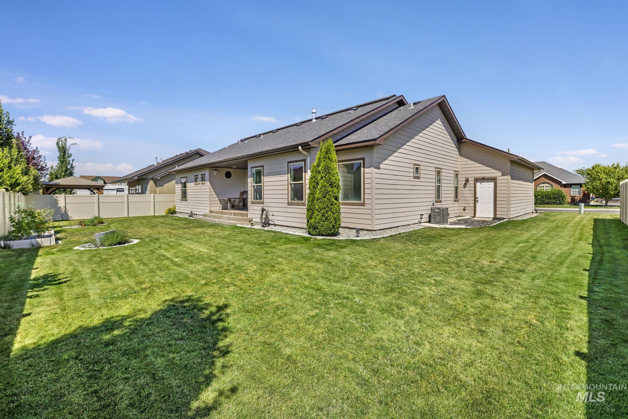 Rear view of property featuring a patio area and roof with shingles