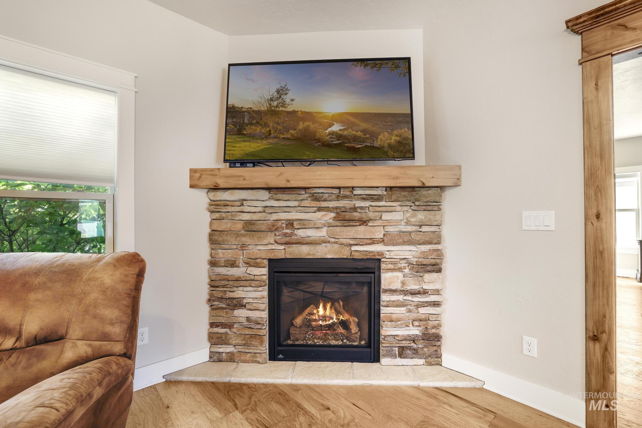 Detailed view of wood finished floors and a fireplace