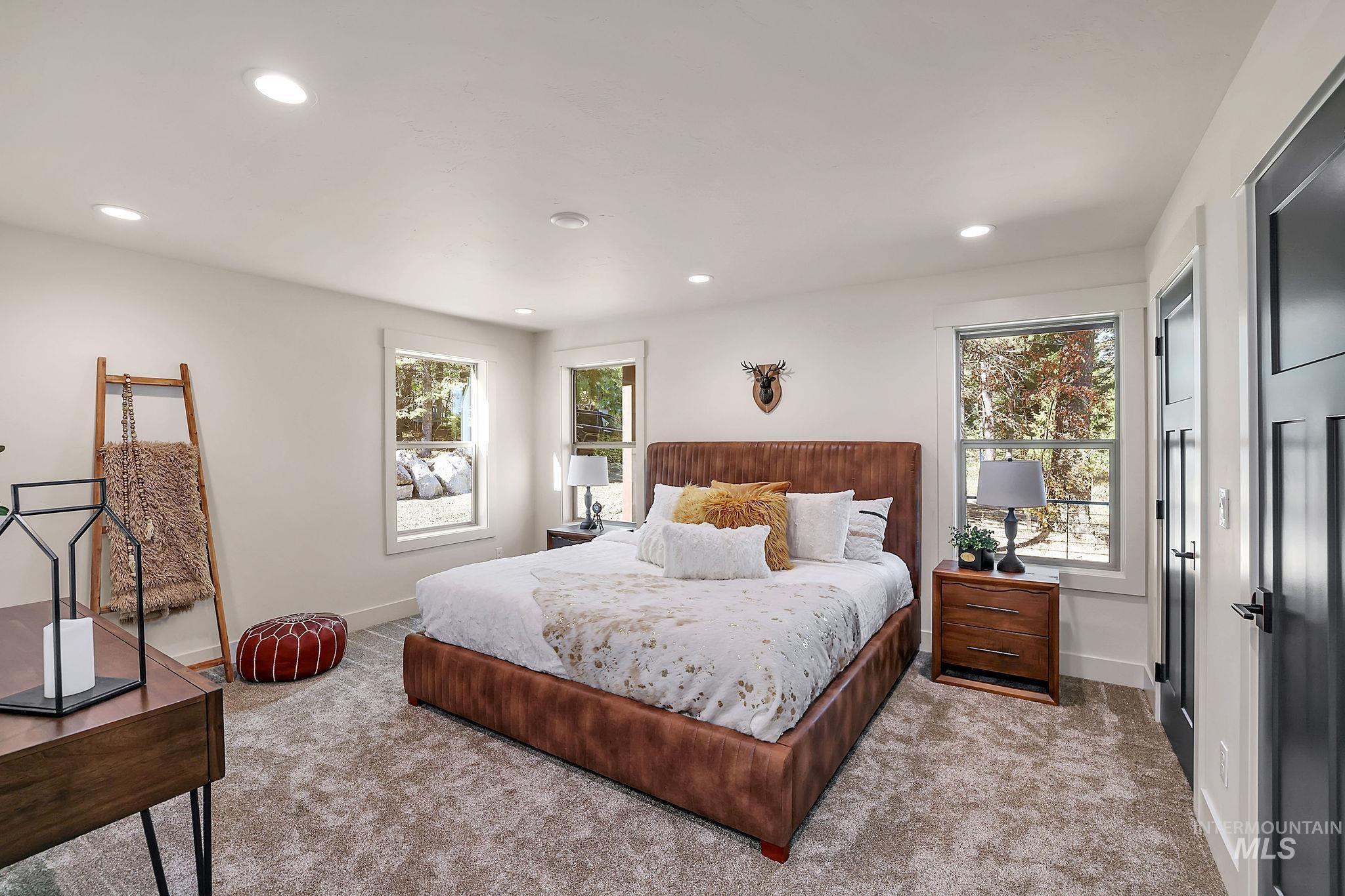 Carpeted bedroom featuring recessed lighting and baseboards