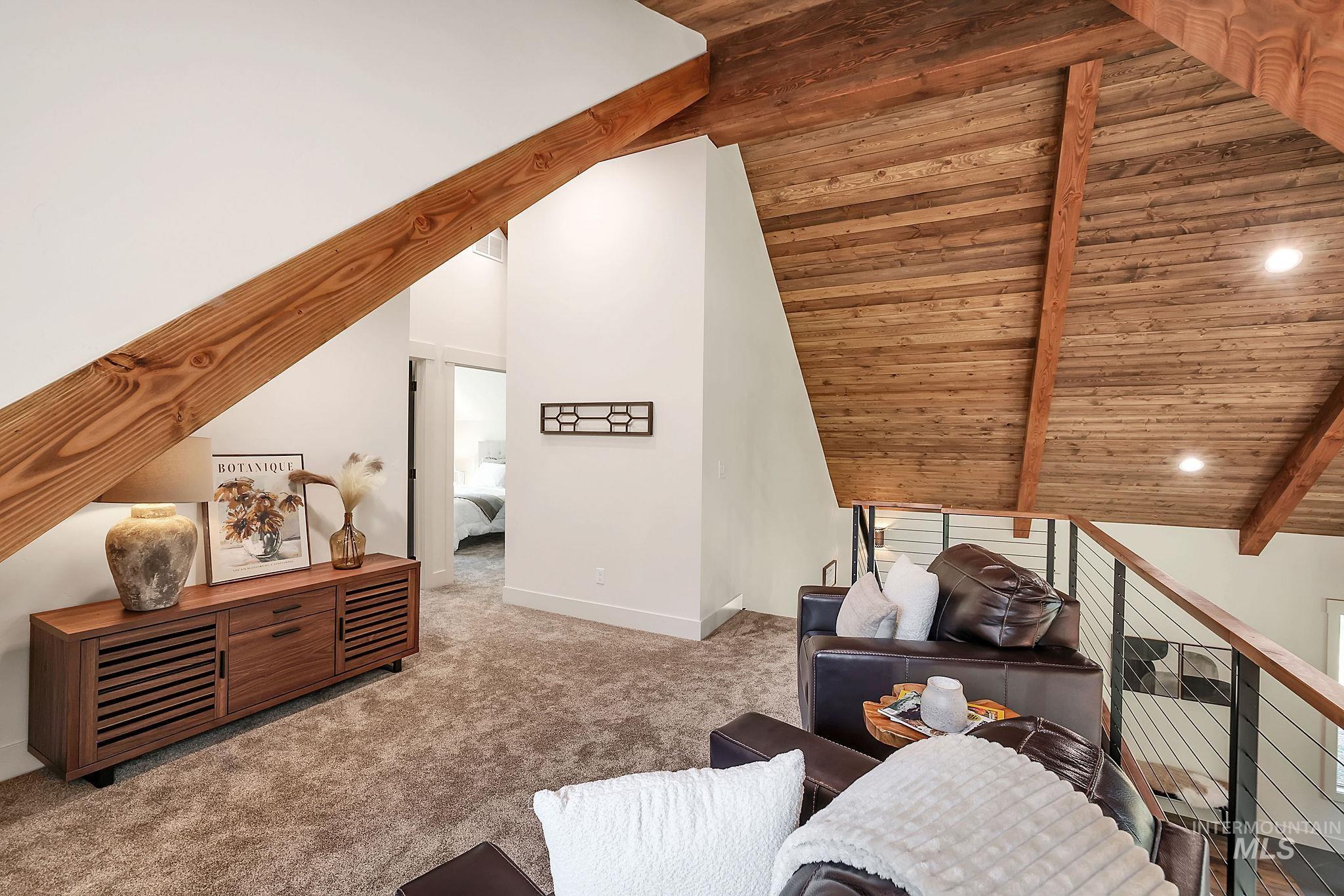 Additional living space featuring wooden ceiling and carpet