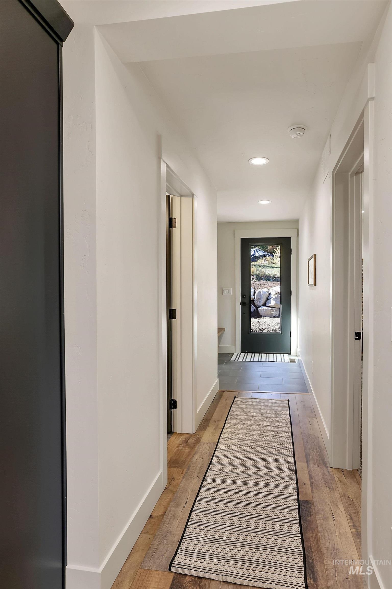Corridor featuring light wood-style floors and recessed lighting