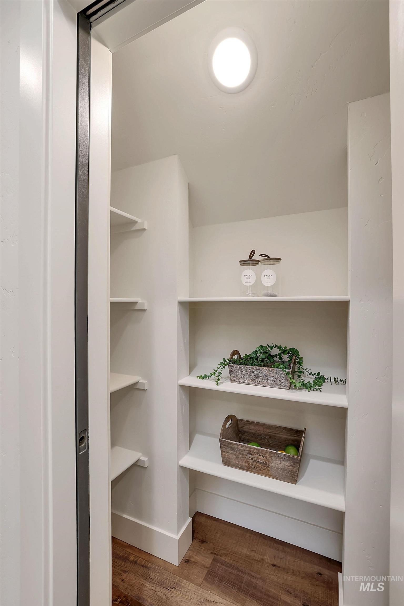 Spacious closet with dark wood-style floors