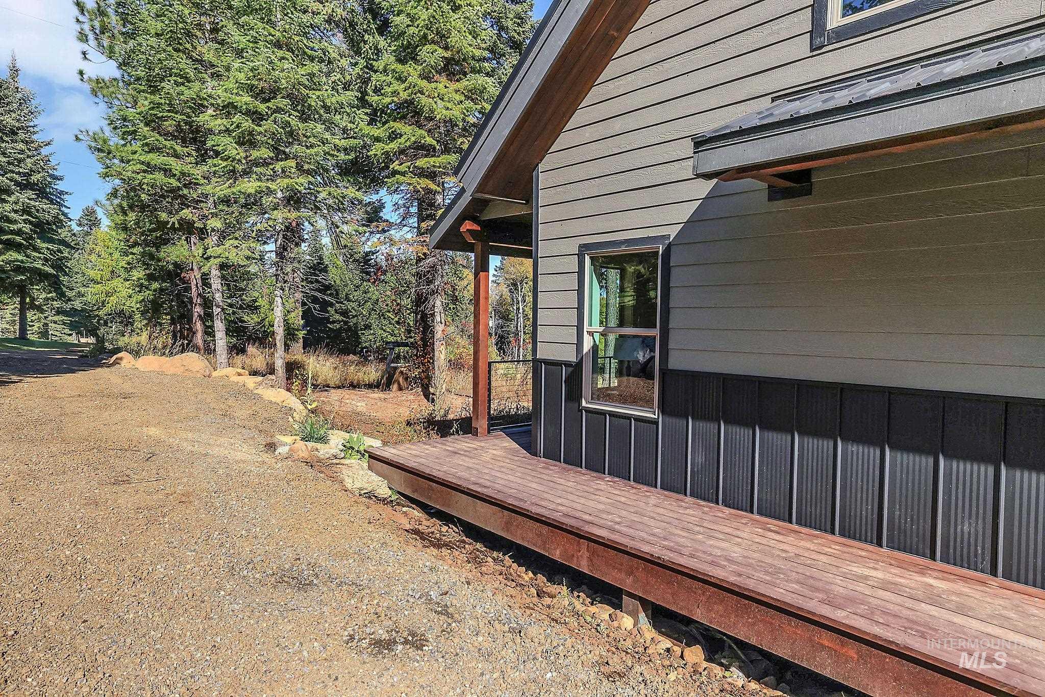 View of side of property featuring a wooden deck