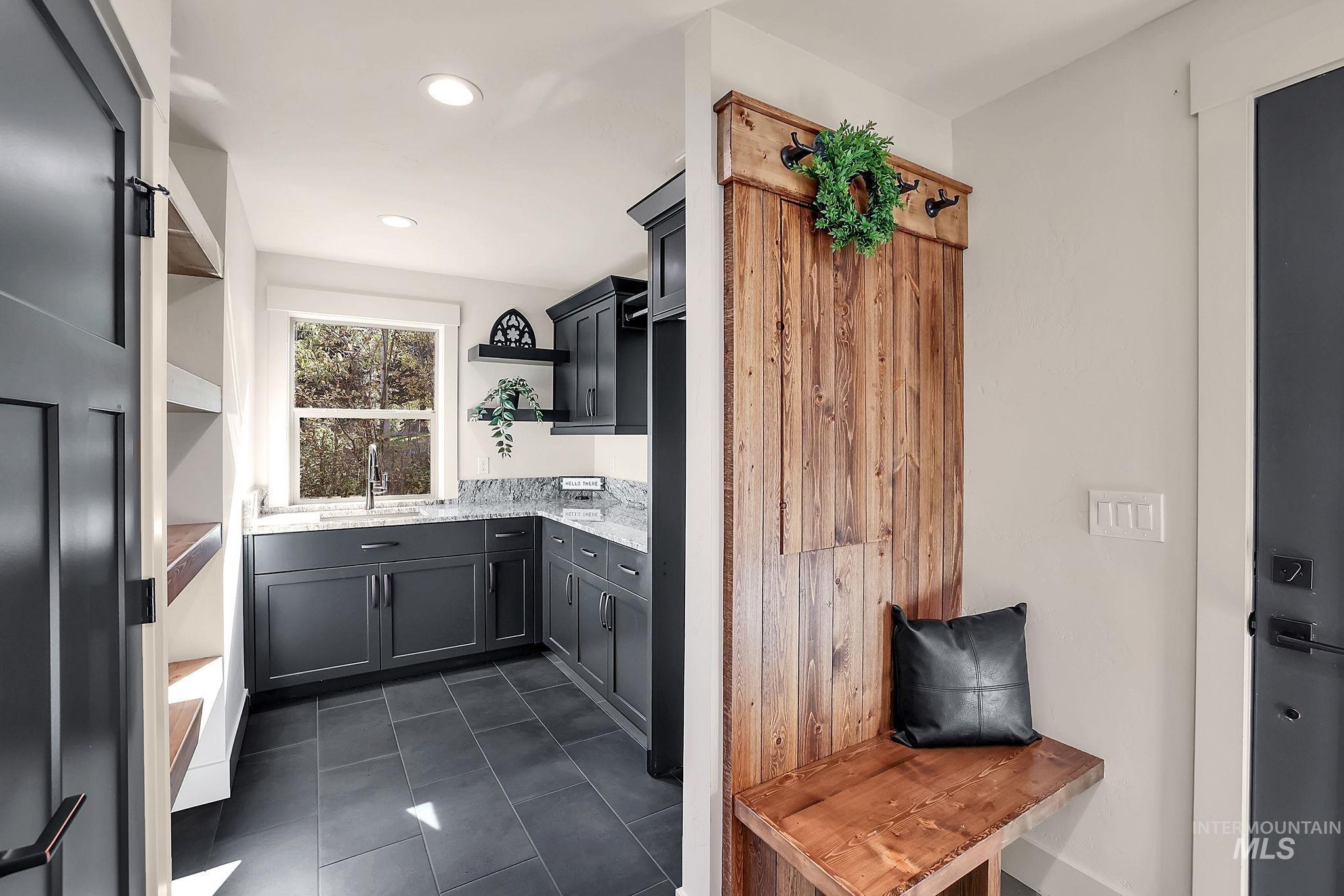 Kitchen with dark tile patterned flooring and recessed lighting