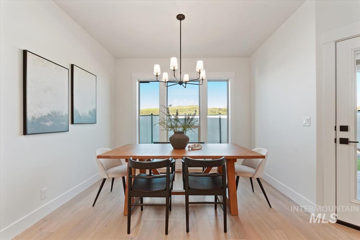 Dining area featuring light wood-type flooring and a chandelier