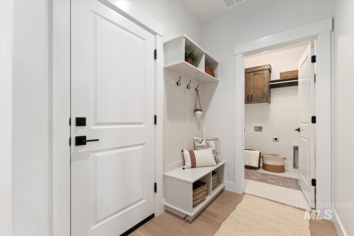 Mudroom with light wood-style flooring