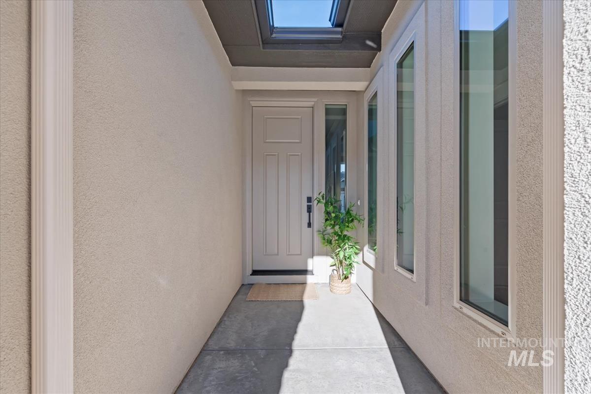 View of exterior entry with stucco siding