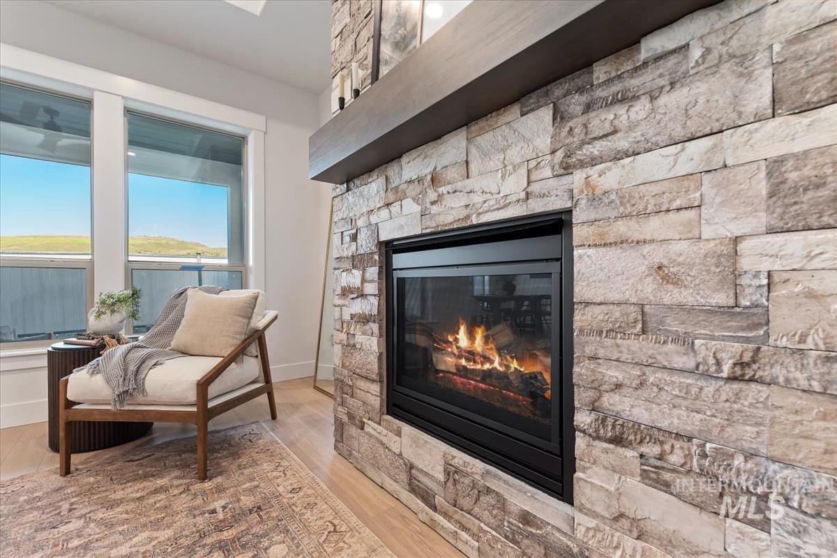 Detailed view of a fireplace and wood finished floors