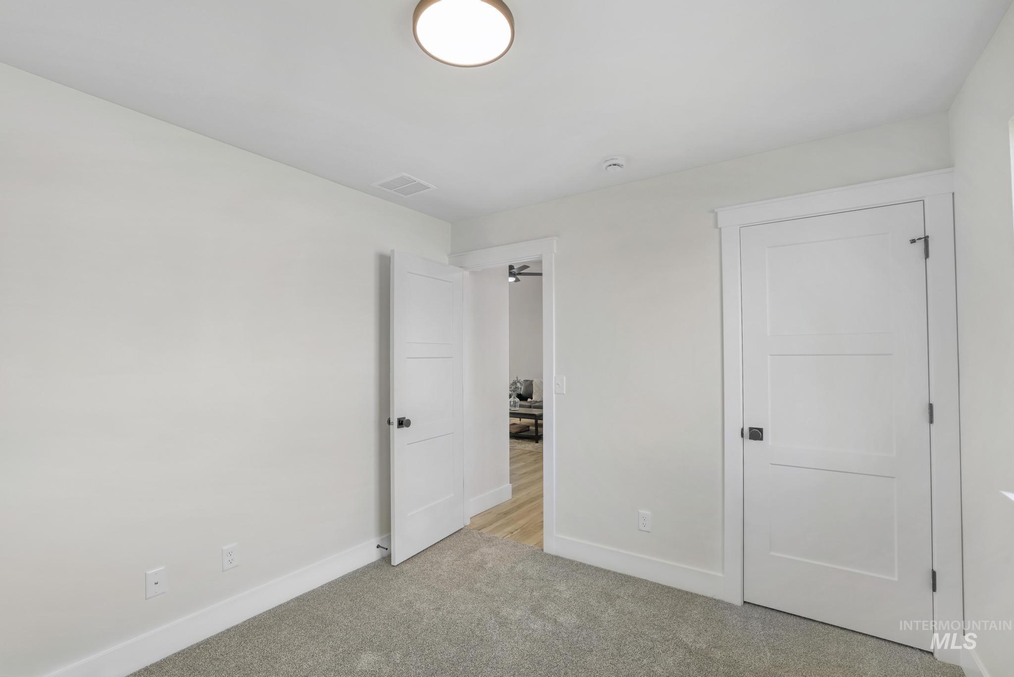 Unfurnished bedroom featuring baseboards and carpet floors