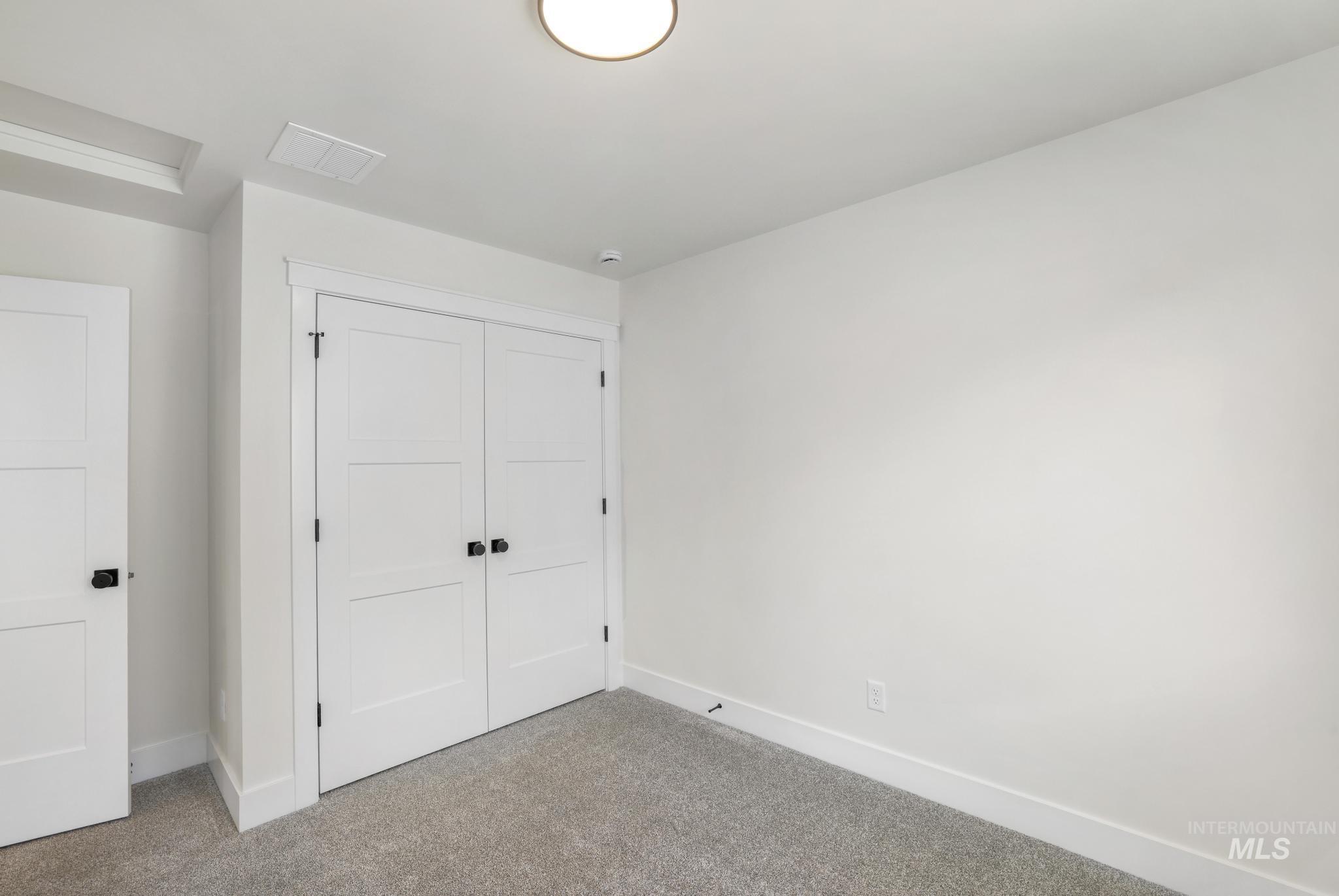 Unfurnished bedroom with carpet flooring and a closet