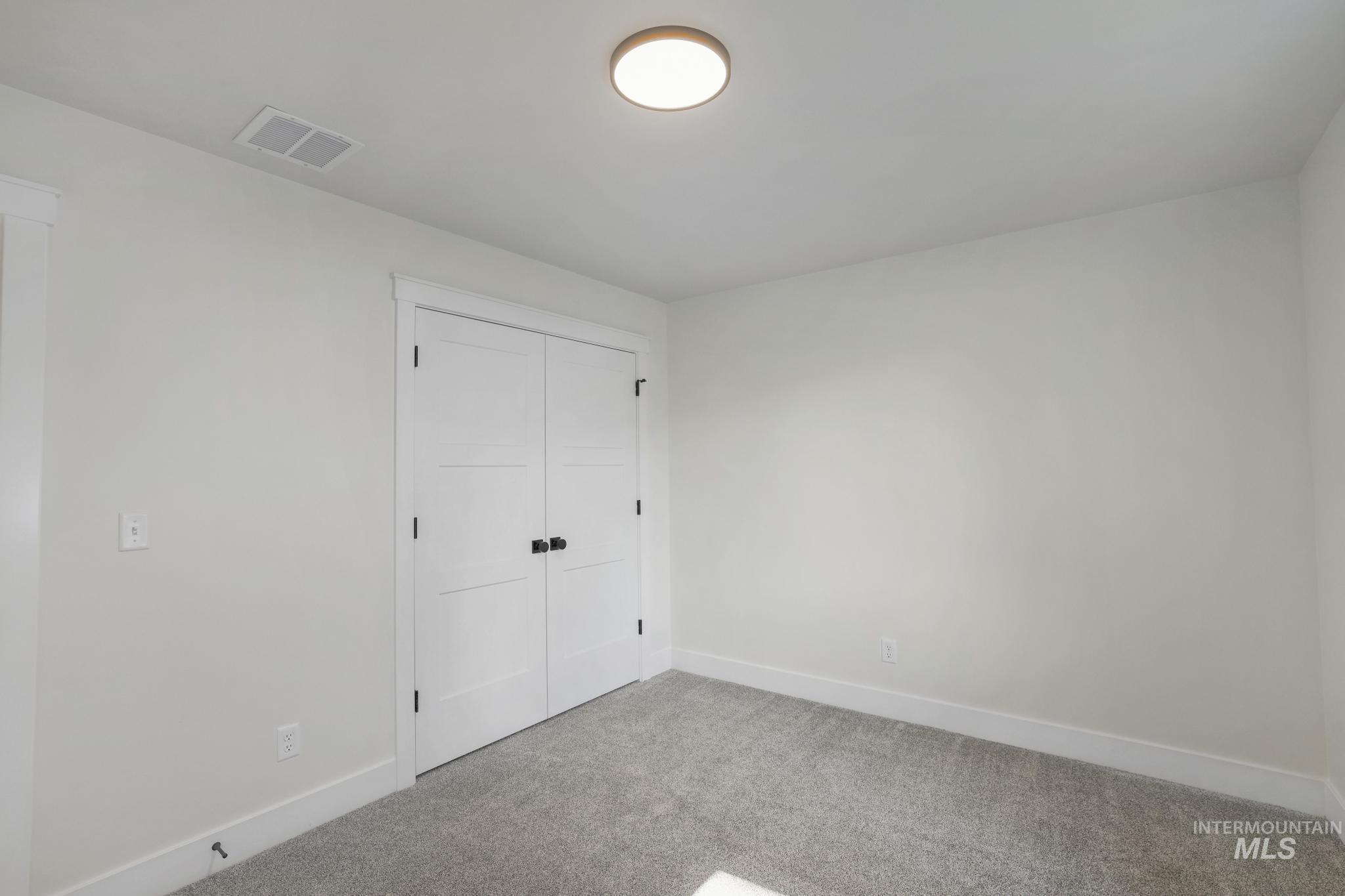 Unfurnished bedroom with carpet flooring and a closet