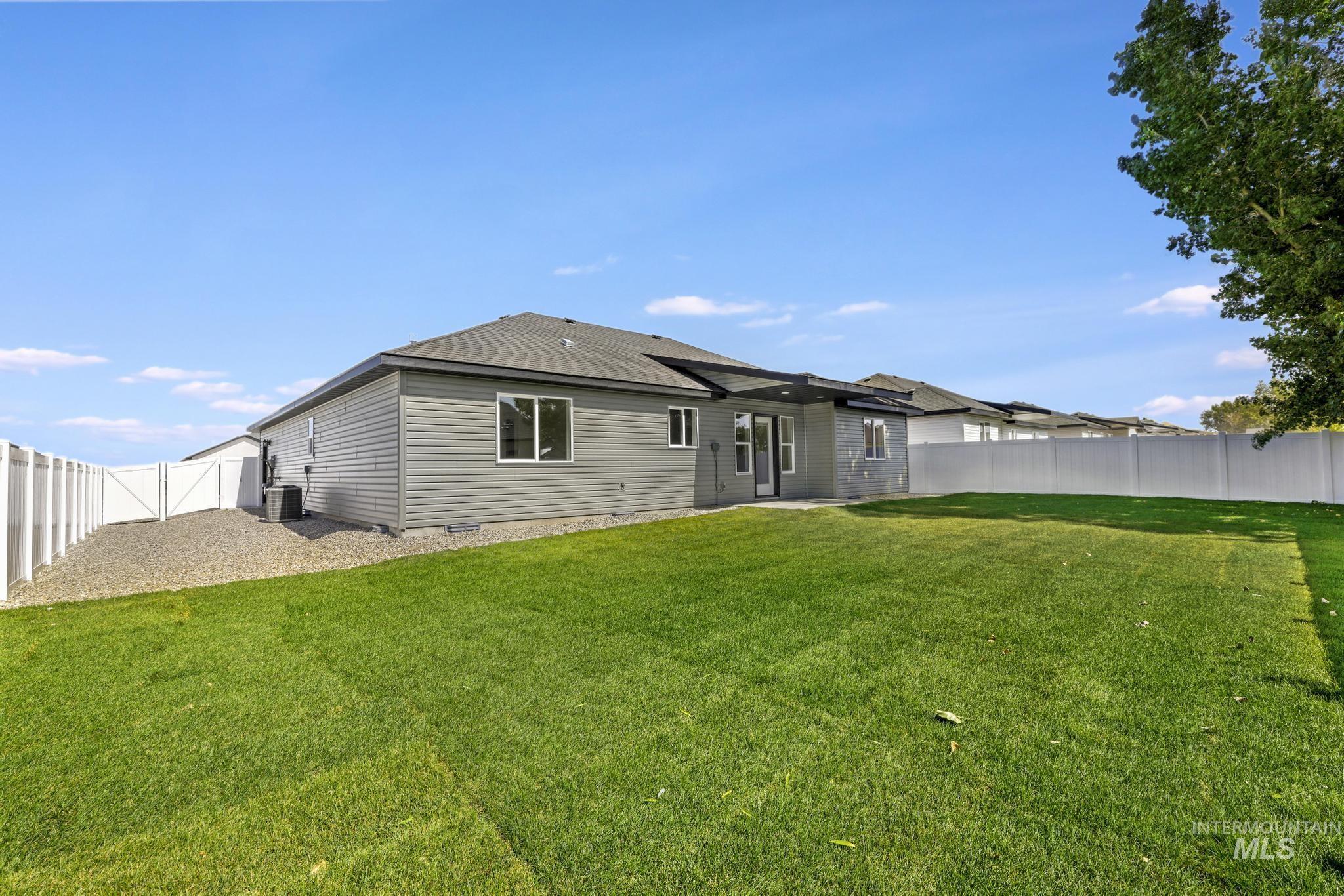 Rear view of house with a patio area, a fenced backyard, roof with shingles, and crawl space