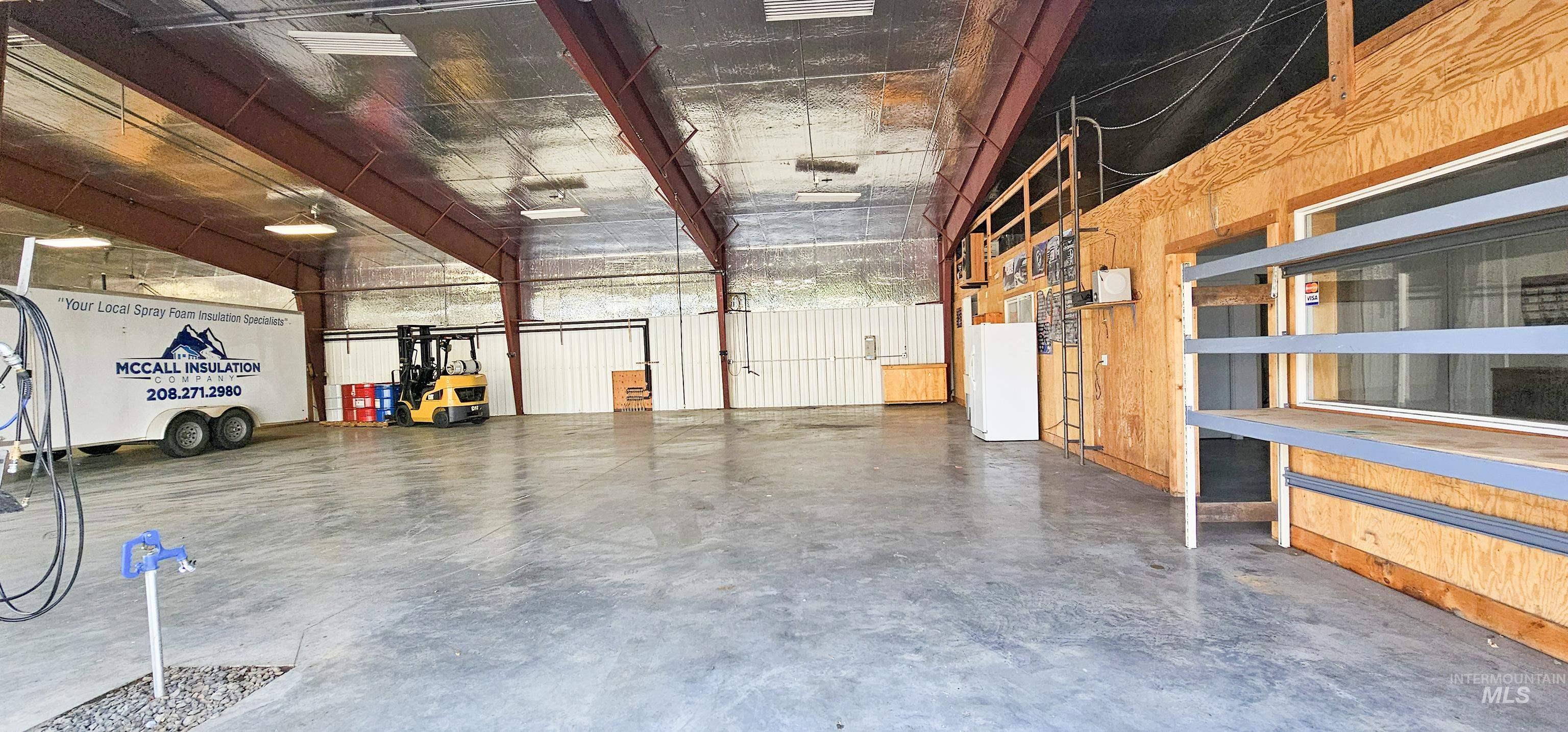 Interior space with concrete floors and wood walls