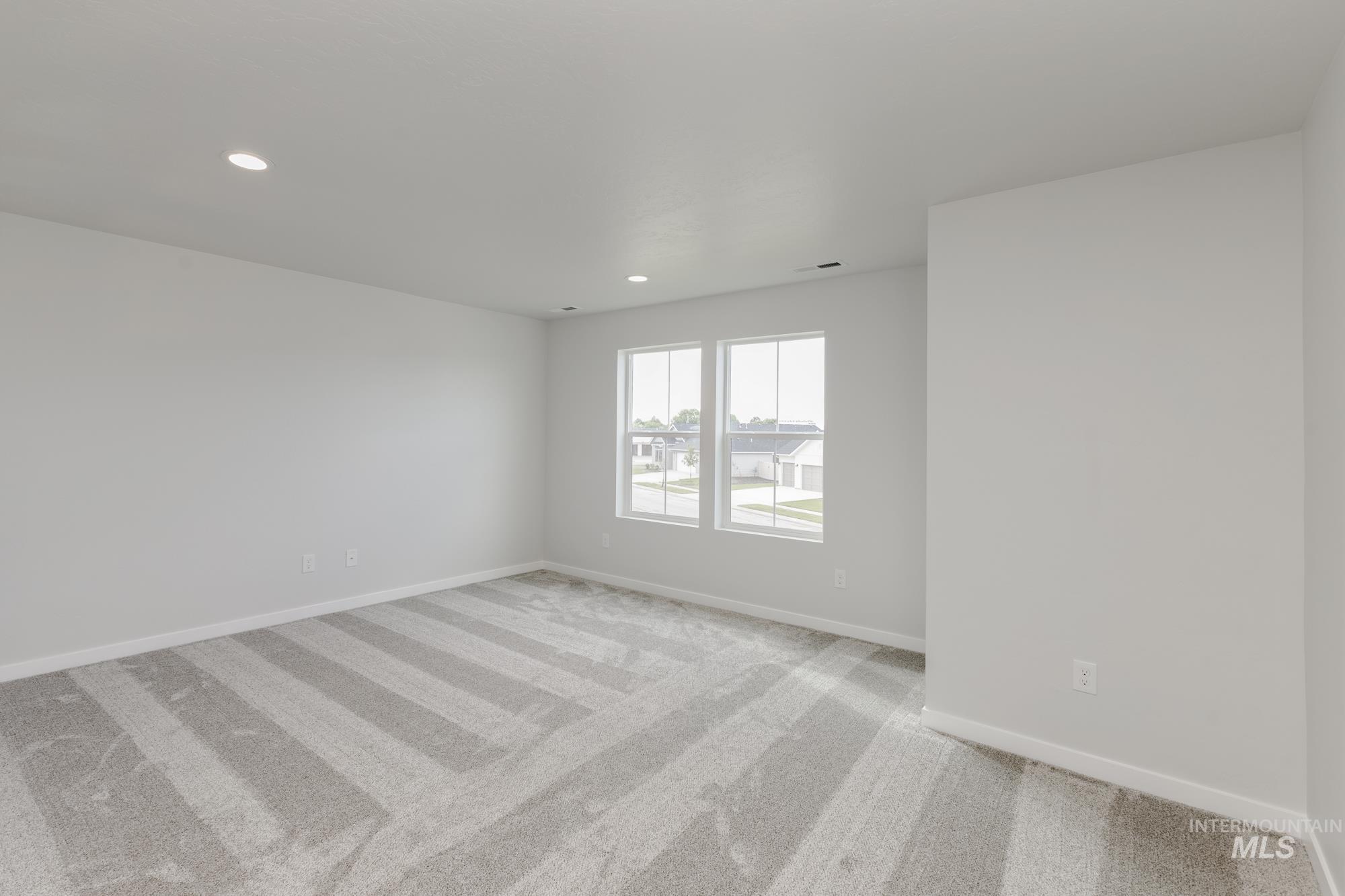Spare room with light carpet and recessed lighting