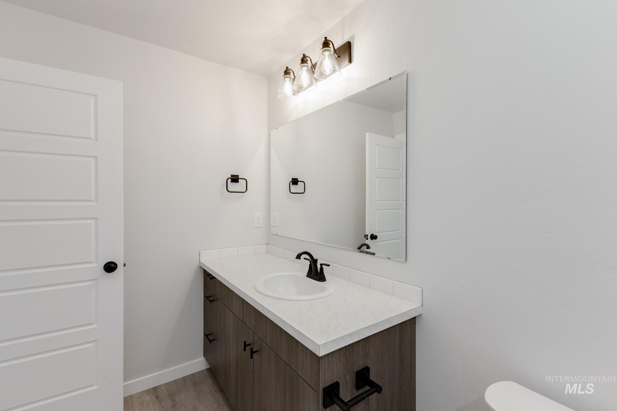 Bathroom featuring vanity and wood finished floors