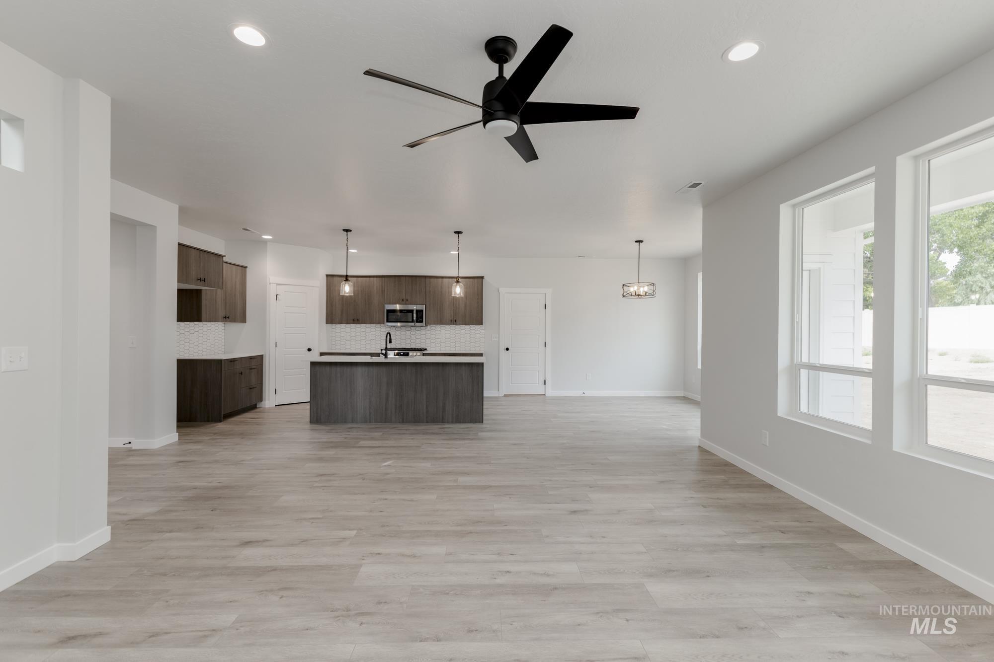 Unfurnished living room with recessed lighting, a ceiling fan, and light wood-style floors