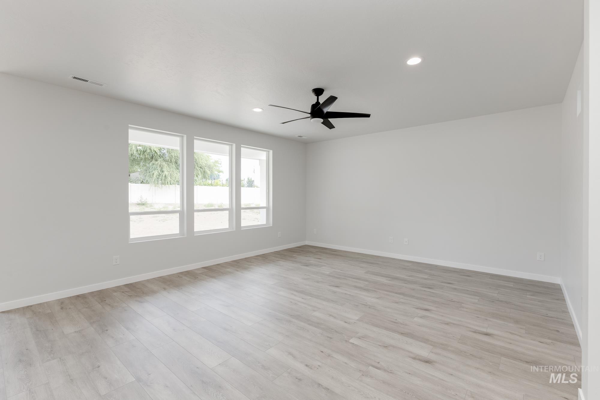 Unfurnished room with ceiling fan, light wood-type flooring, and recessed lighting