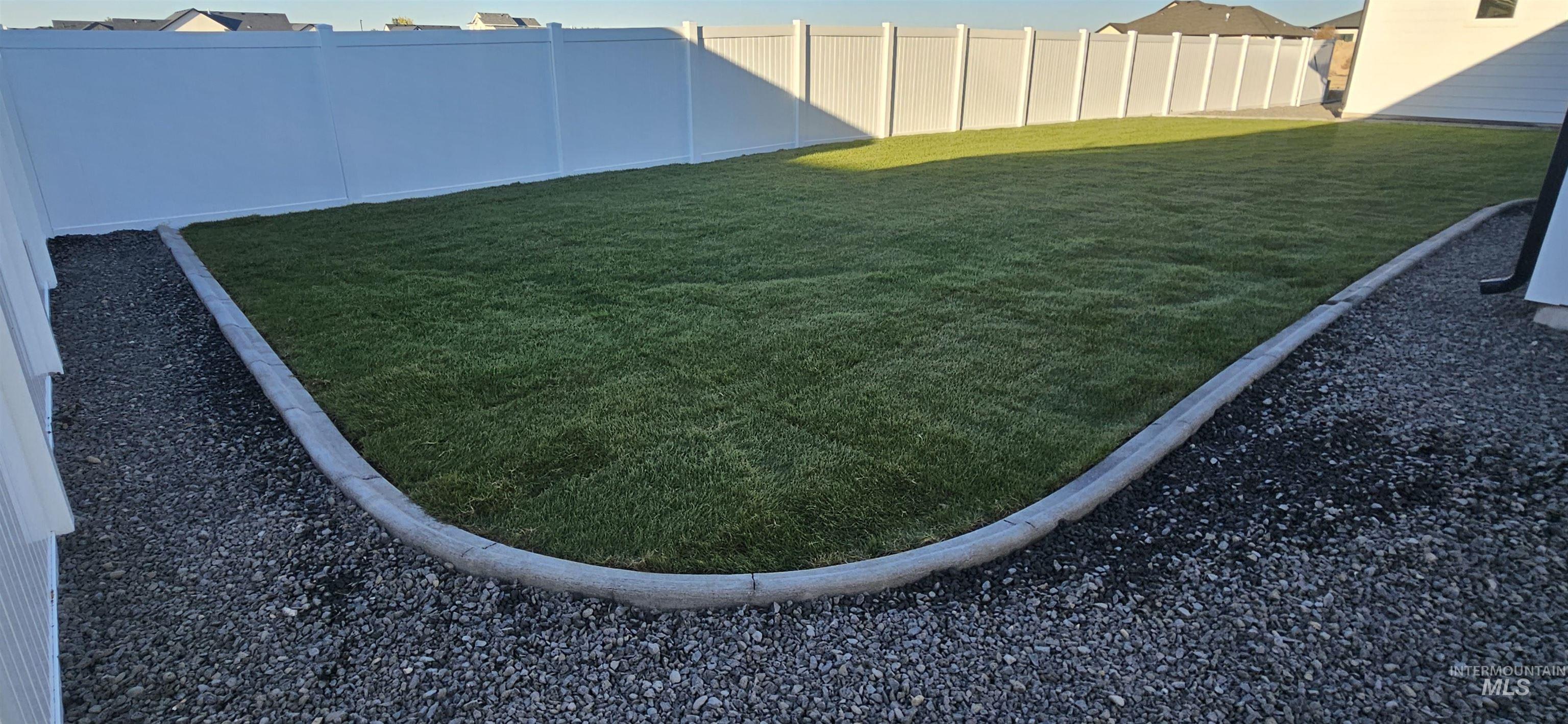 View of fenced backyard