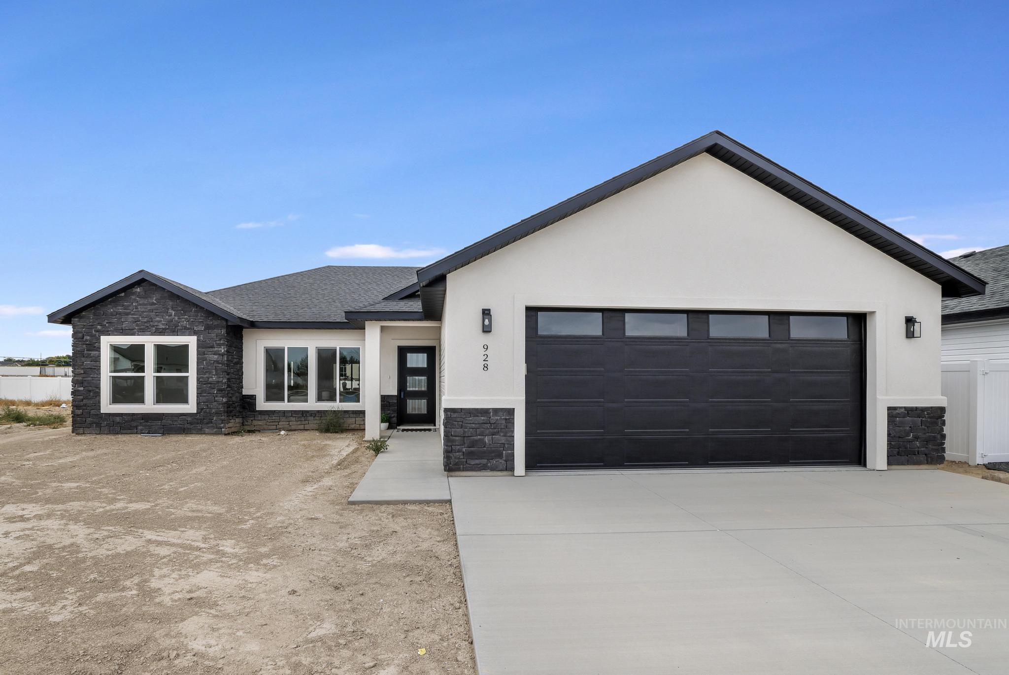 View of front of property with stone siding, a shingled roof, stucco siding, and concrete driveway