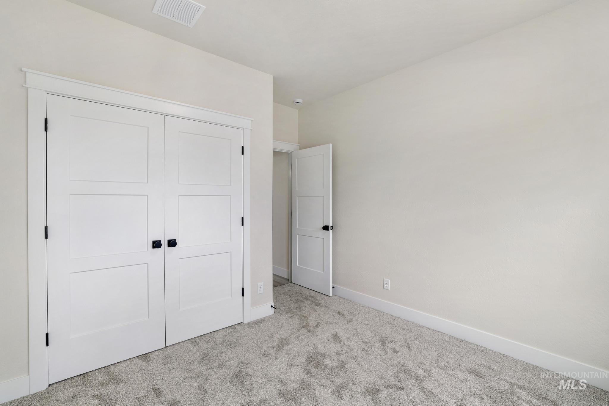 Unfurnished bedroom with carpet floors and a closet