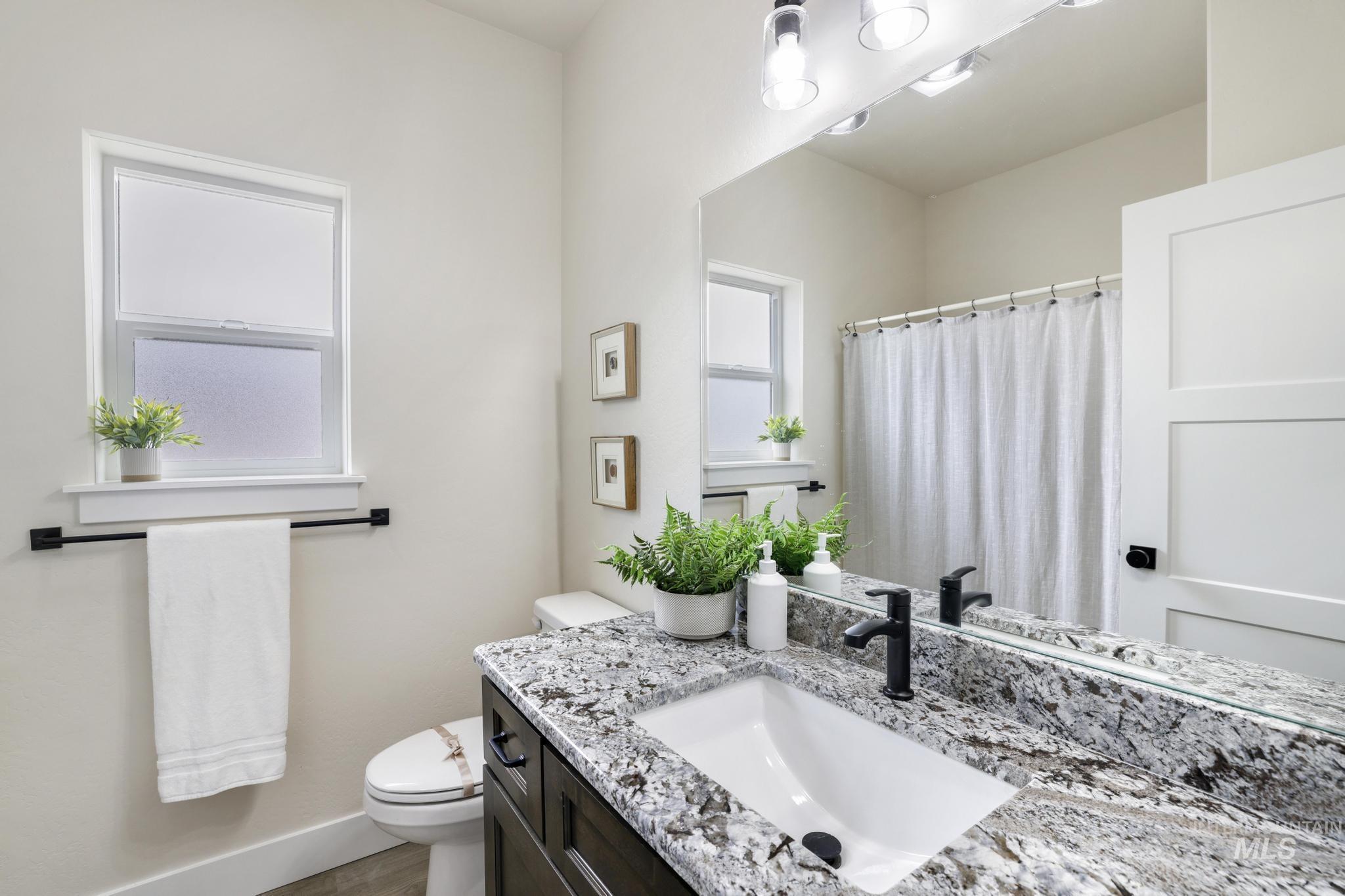 Bathroom featuring vanity and a shower with shower curtain