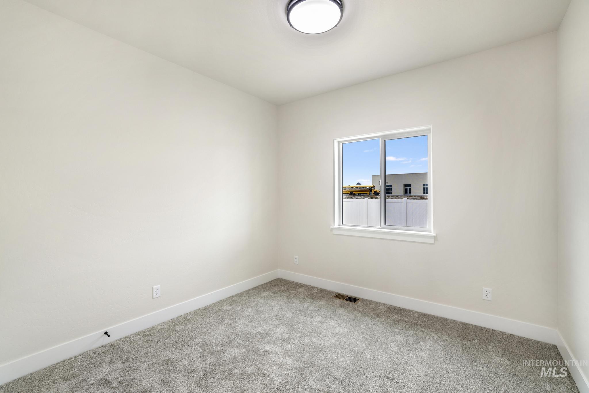 Empty room with baseboards and carpet