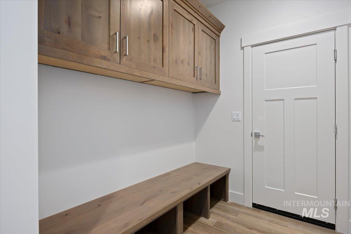 Mudroom with light wood-style flooring