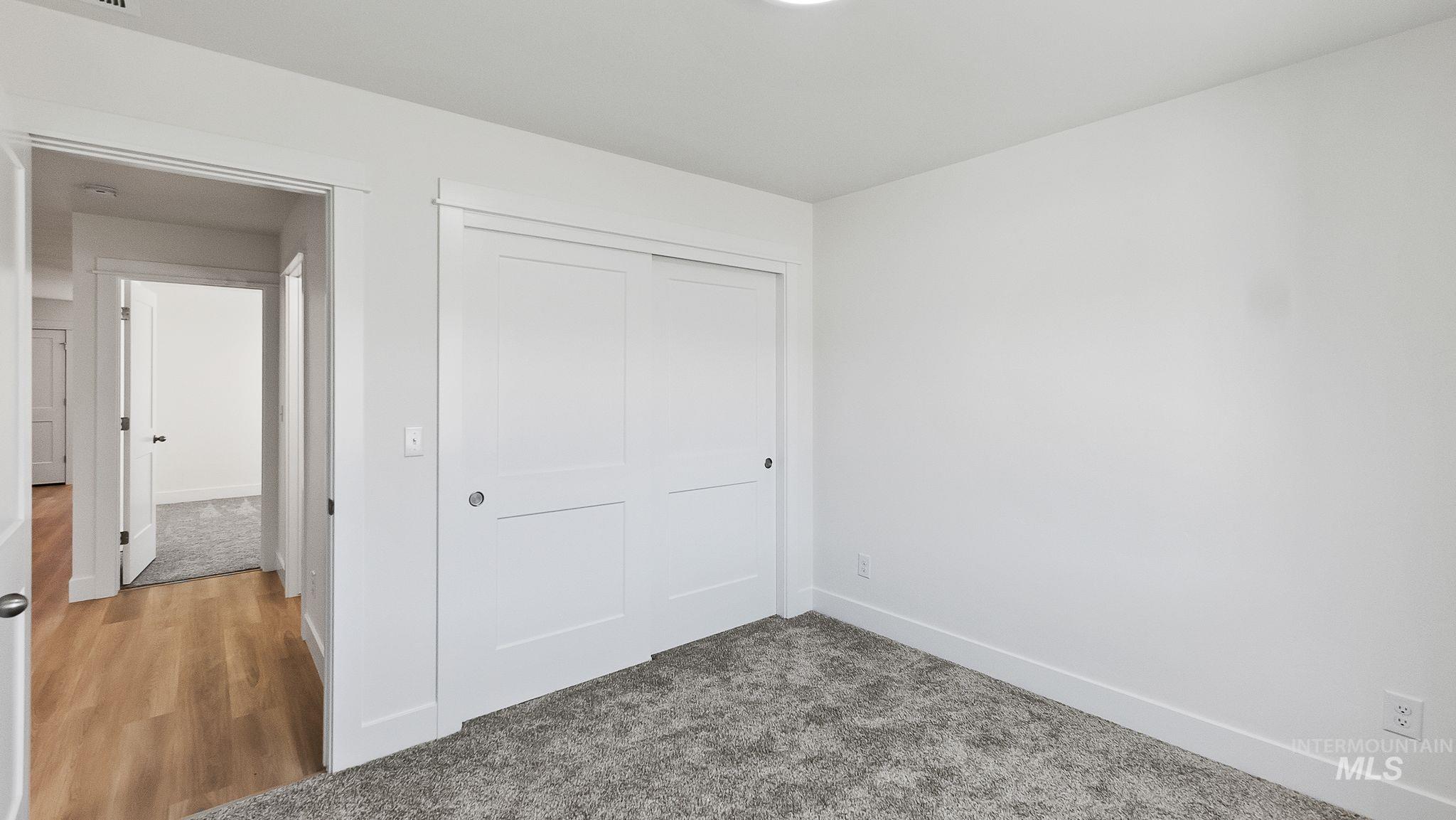 Unfurnished bedroom with a closet and carpet