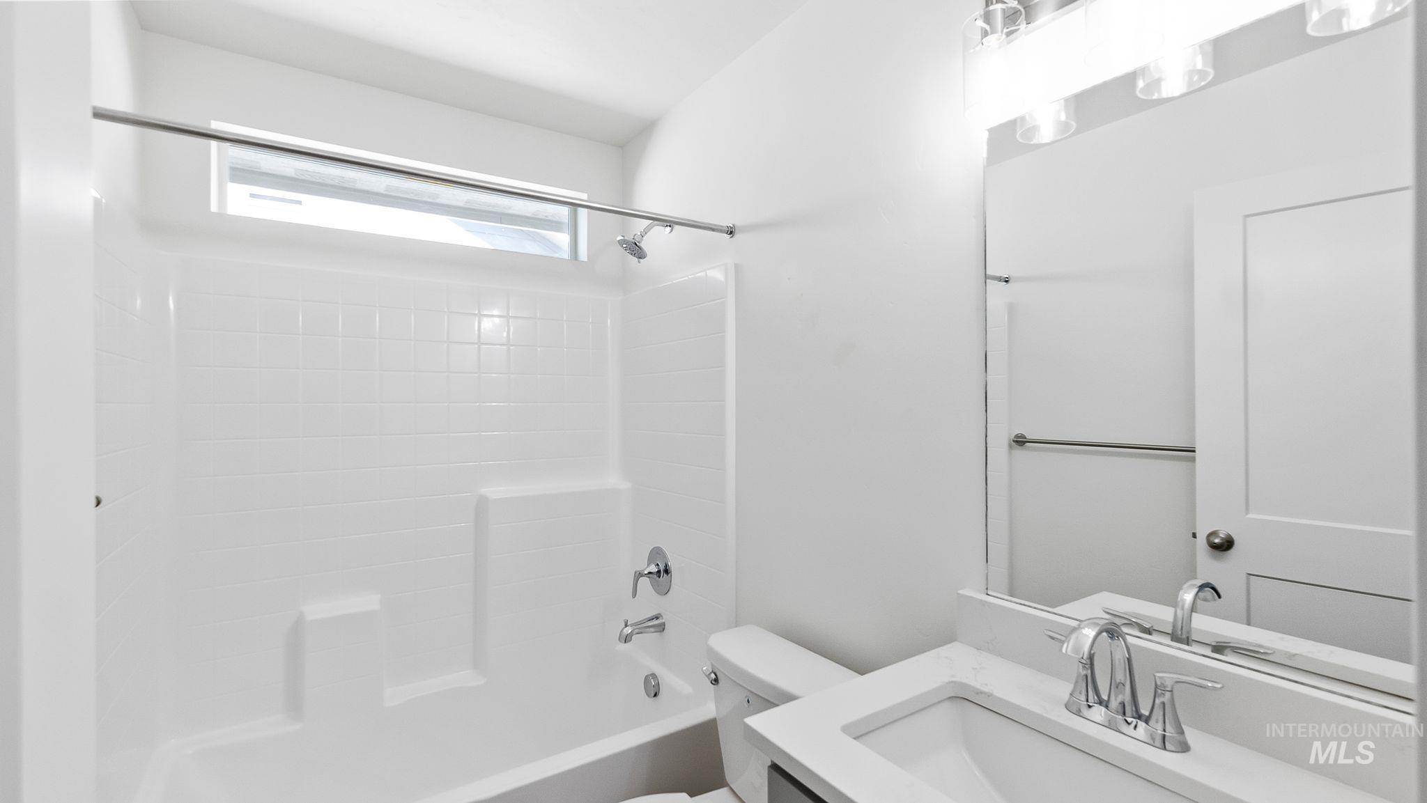 Full bath featuring vanity and shower / tub combination