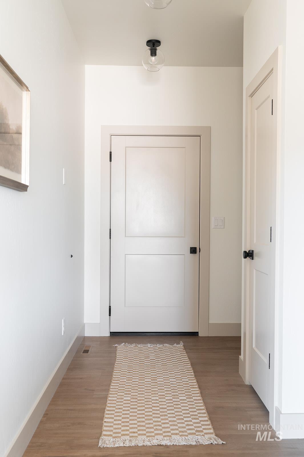 Doorway to outside with light wood-style floors