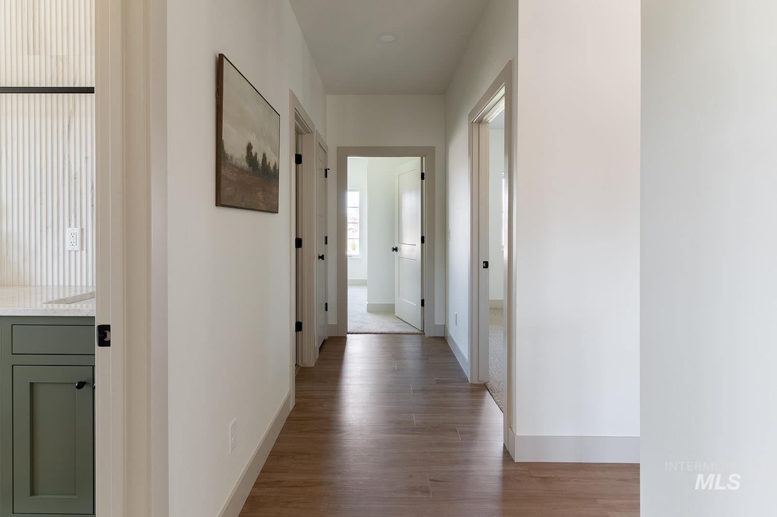 Corridor featuring baseboards and light wood-type flooring