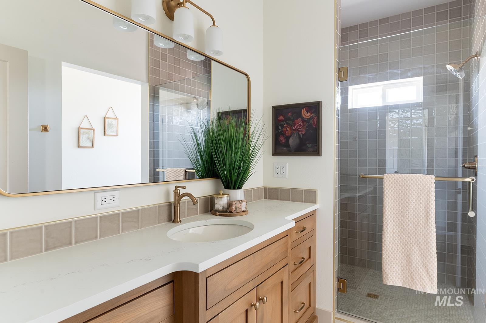 Full bathroom featuring a stall shower and vanity