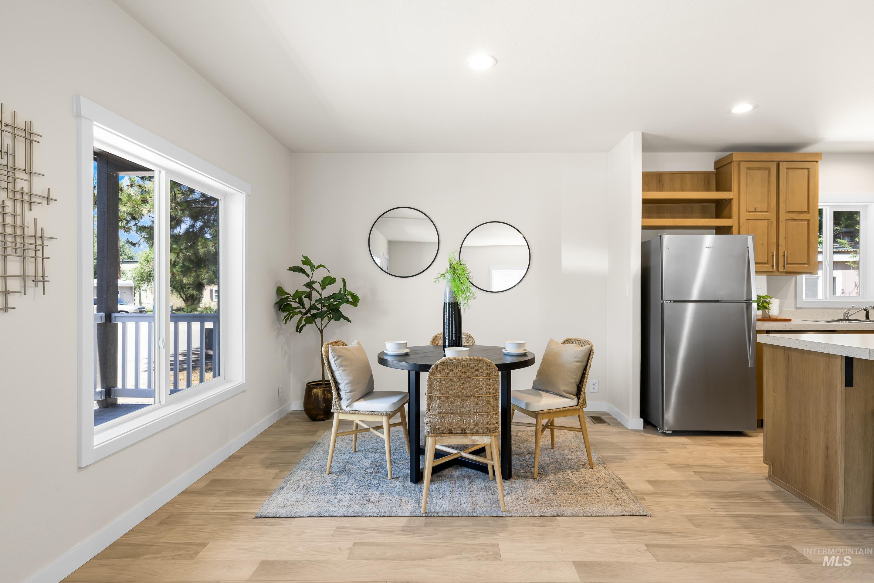 Dining space with plenty of natural light, light wood-type flooring, and recessed lighting
