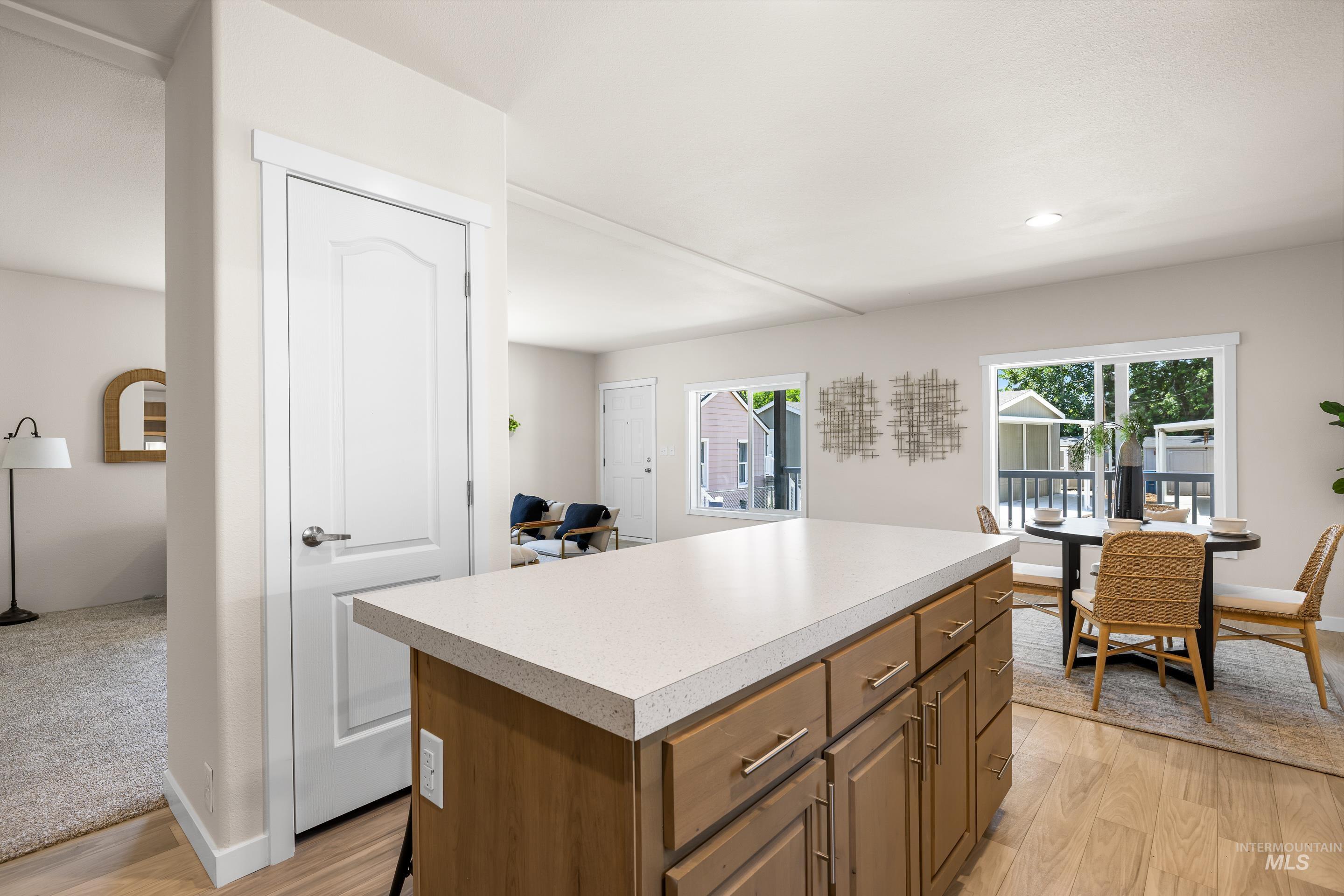Kitchen featuring a kitchen island, light wood finished floors, light countertops, and recessed lighting
