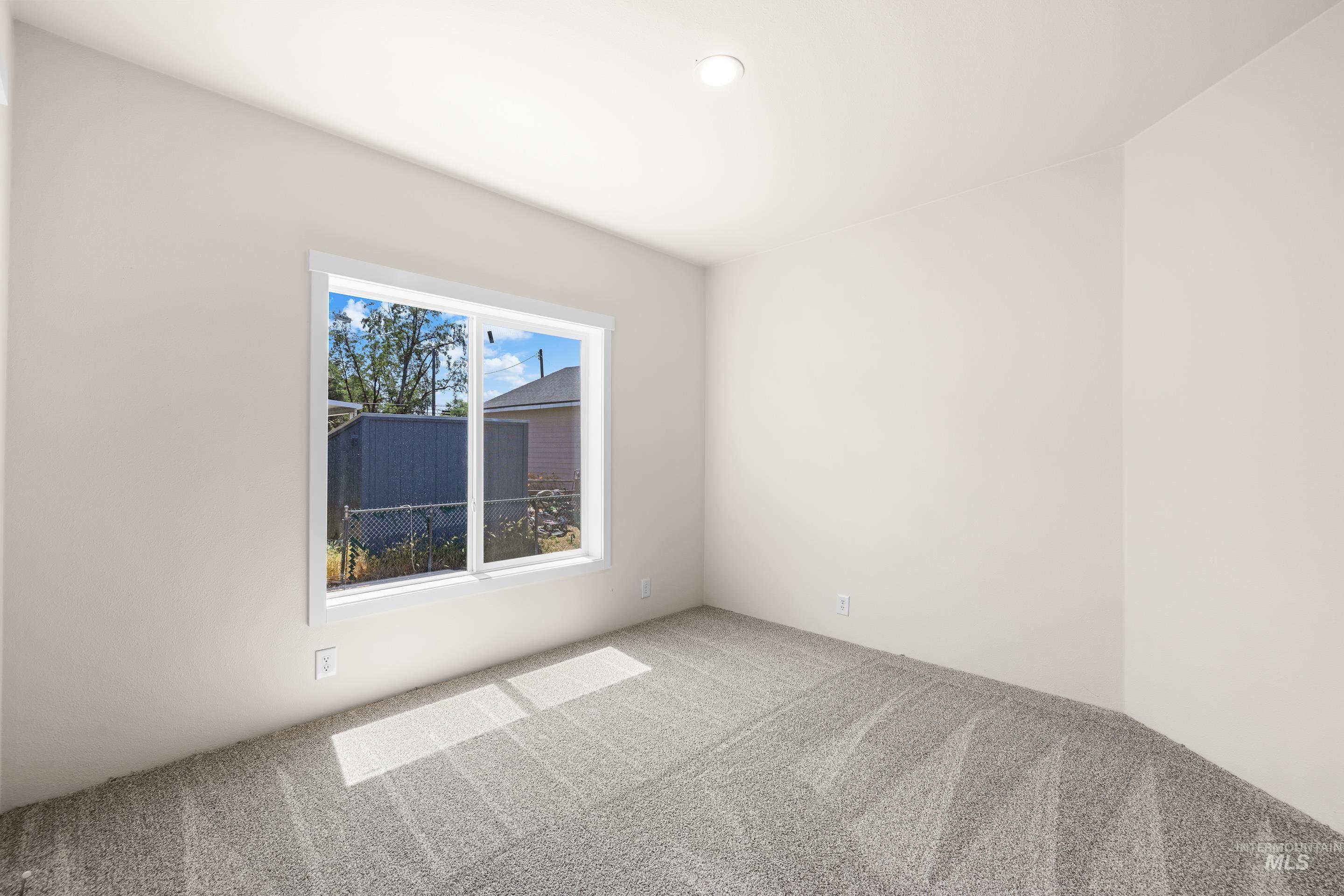 Empty room with carpet flooring and recessed lighting
