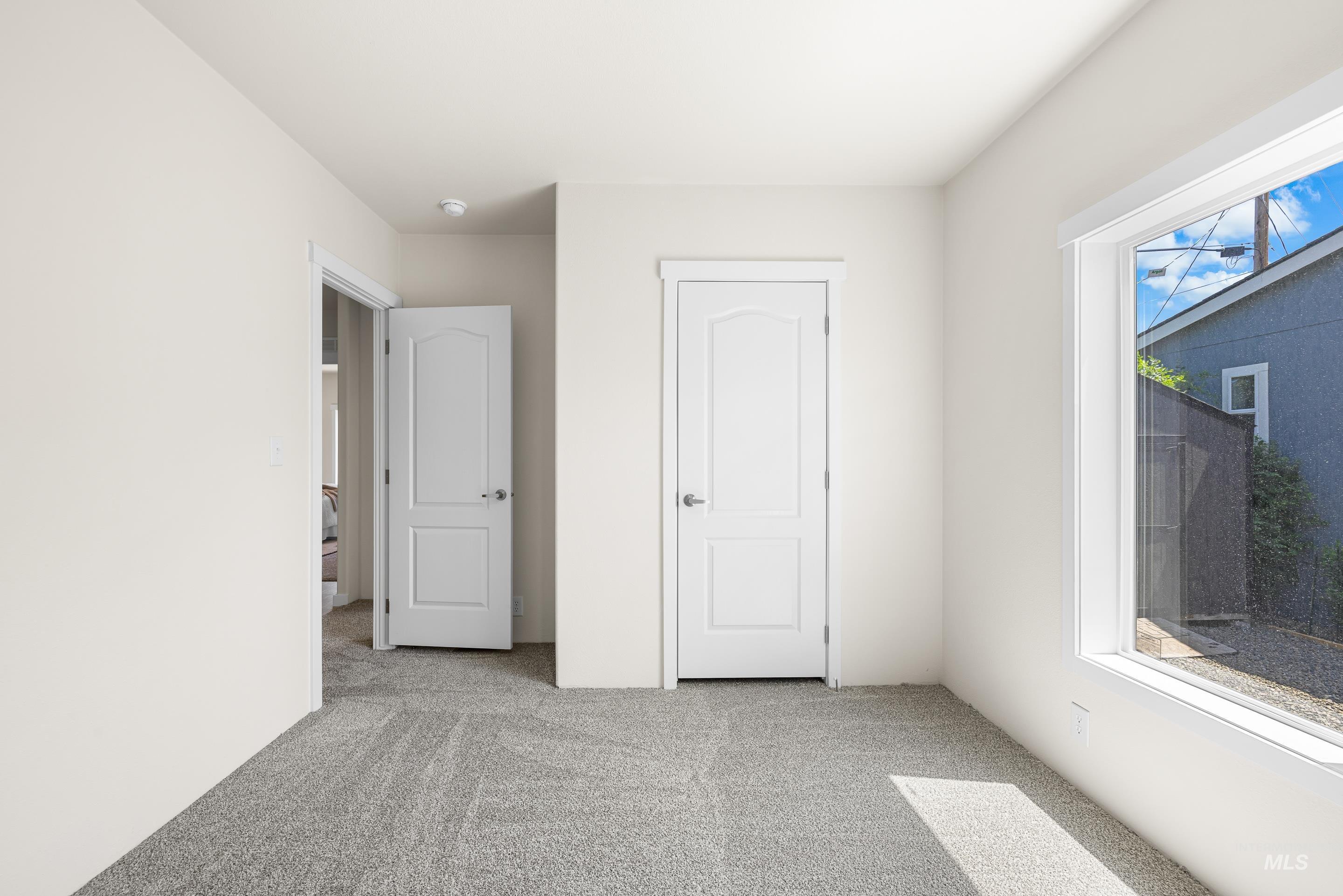 Unfurnished bedroom with carpet