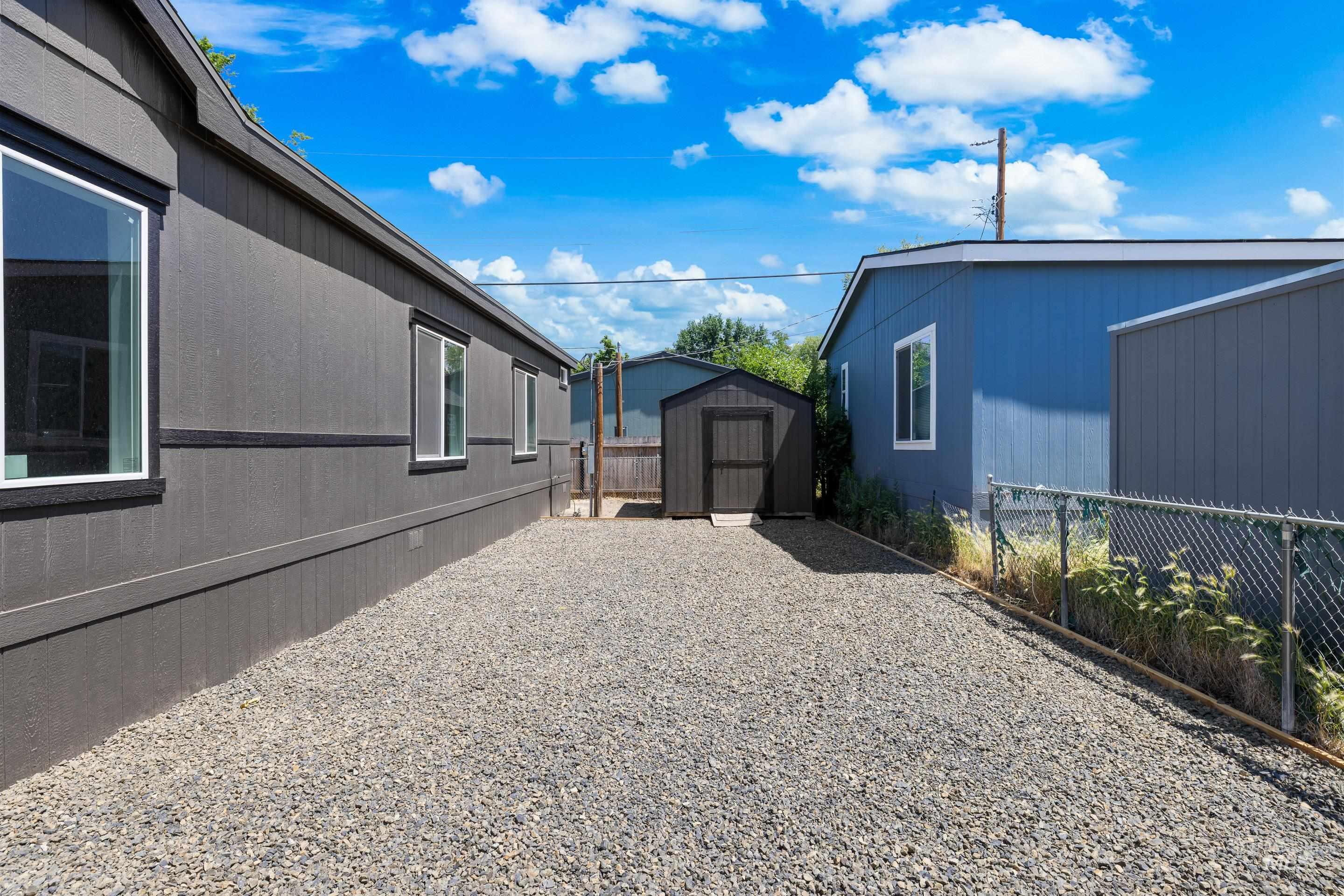 View of property exterior featuring a storage unit