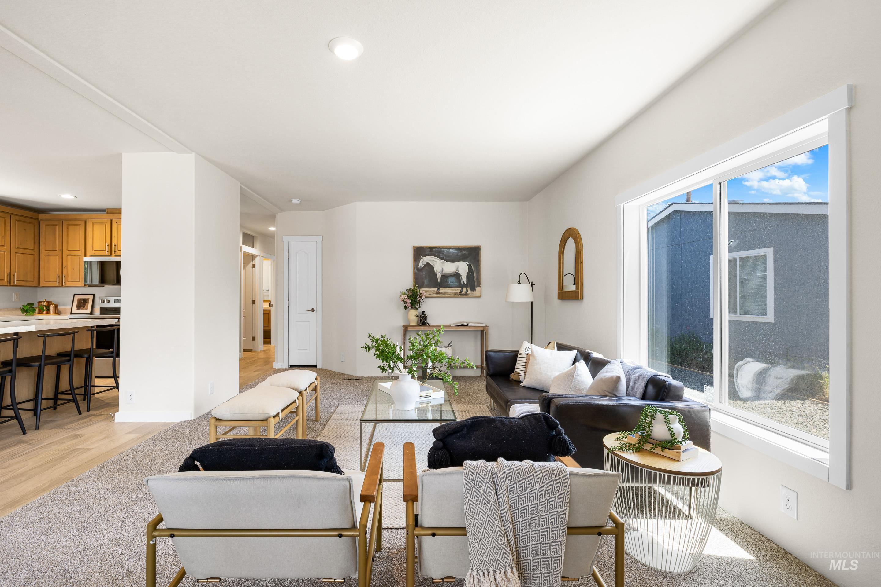 Living area with recessed lighting and light wood-style floors